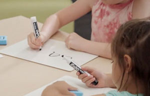 students writing with markers